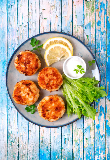 istock Cutlets with codfish and shrimps on the plate on blue wooden table 1552776686