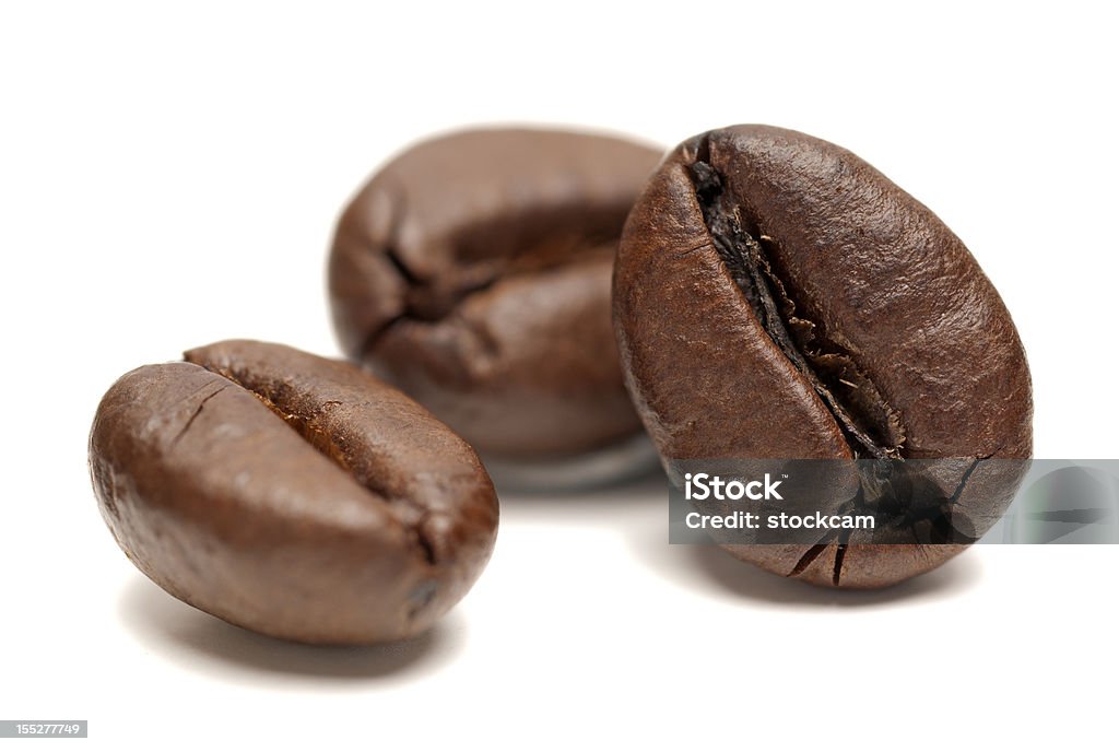 Macro of Coffee Beans on white background Closeup of coffee beans on a white background. Roasted Coffee Bean Stock Photo
