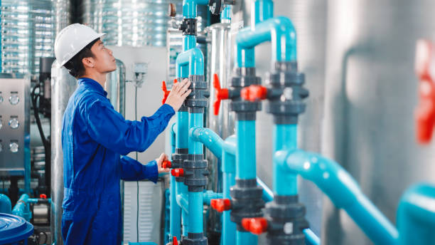 Maintenance engineer working in the water factory stock photo