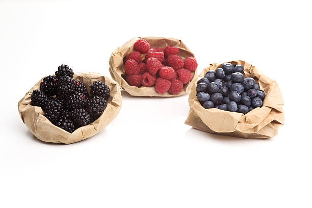 blueberries and raspberries on a wooden board background wood