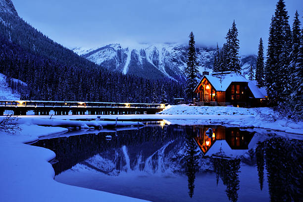 Emerald Lake Resort Entrance The road leading into Emerald Lake Lodge in Yoho National Park, British Columbia. The Restaurant reflects on the unfrozen water in this winter scene yoho national park photos stock pictures, royalty-free photos & images