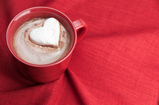 Heart shaped marshmallow in a mug of hot chocolate.