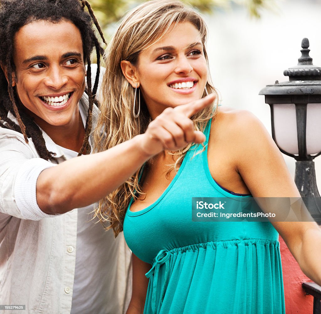 Young beautiful brazilian couple enjoying each other's company on balcony. Young beautiful brazilian couple enjoying each other's company on balcony. Happy and positive emotions. Adolescence Stock Photo