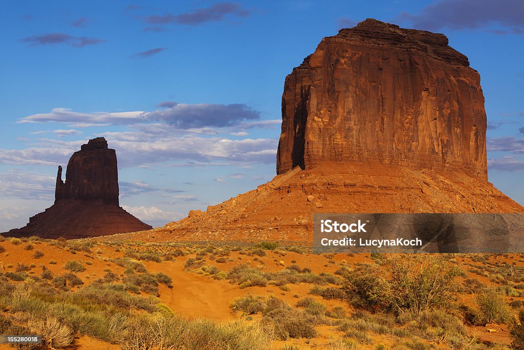 Monument valley, Navajo Tribal Park, Utah-Arizona Rock formations with bush and grass in the Navajo park Monument Valley. Adventure Stock Photo