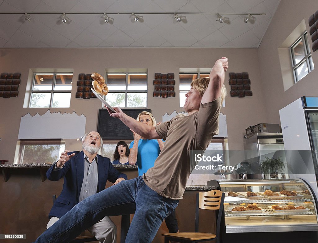 Bagels Anyone A young water slips on water while trying to serve his customers their bagels. (some motion blur) Falling Stock Photo