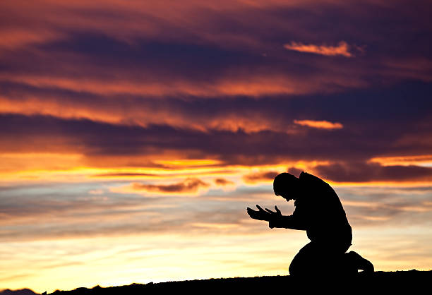 istock Silhouette of a Distraught Man Against a Sunset 155280356