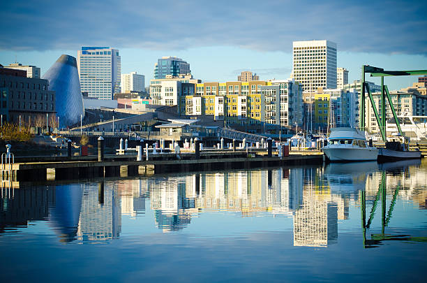 Foss Waterway with buildings and skyline in Tacoma, WA Skyline consisting of office buildings, condominiums and museums of Tacoma, WA reflects off of the Foss Waterway.  tacoma stock pictures, royalty-free photos & images