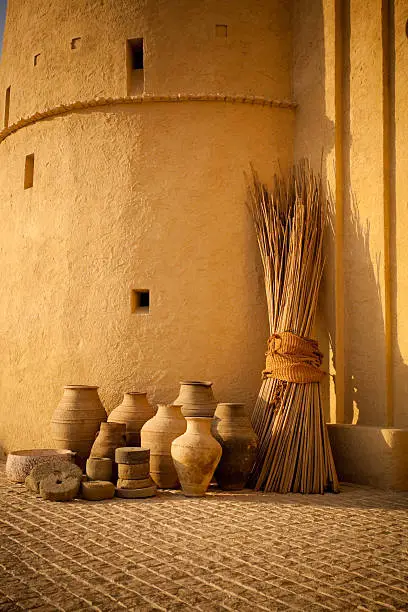 ancient clay pots and vases decorated on wall of nubian fort