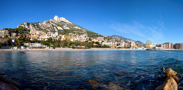 Marquet beach, Cap d'Ail, French Riviera. Appartment buildings on the far right are in Monaco, rock formation is the Tête de Chien. Hi-res composite of 10 images