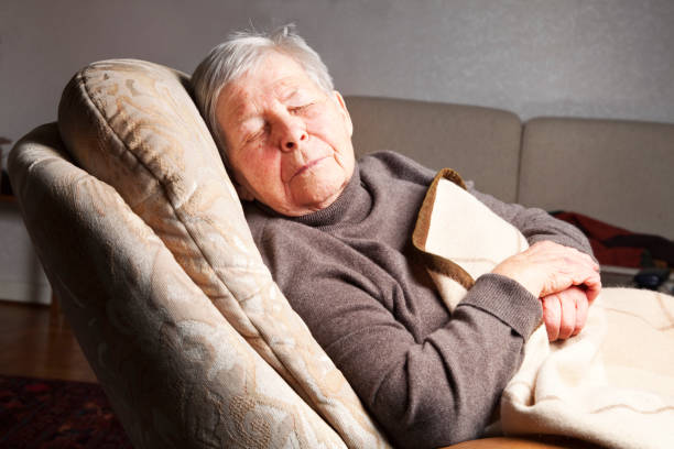 istock senior woman sleeping in chair 155280539