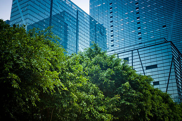 modern office building with green plant http://farm9.staticflickr.com/8125/8659505173_b0341b5425.jpg green skyscraper stock pictures, royalty-free photos & images