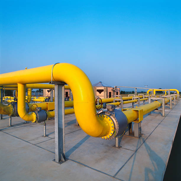 Yellow pipes in a gas distribution station, blue sky background stock photo