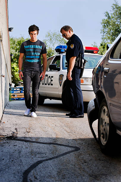 Police officer giving a man a field sobriety test stock photo