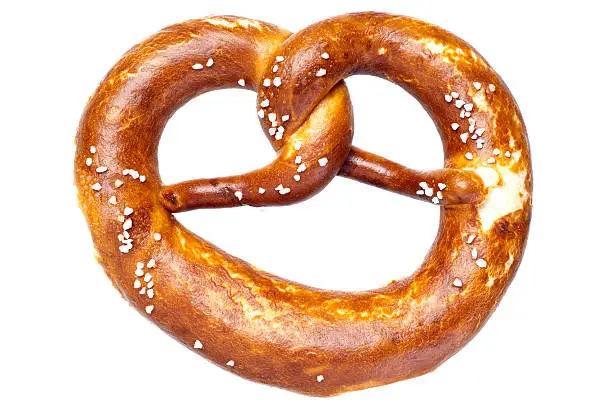 A Bavarian soft pretzel, isolated on white.