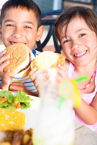 istock Sibling enjoying BBQ outdoor 155282100