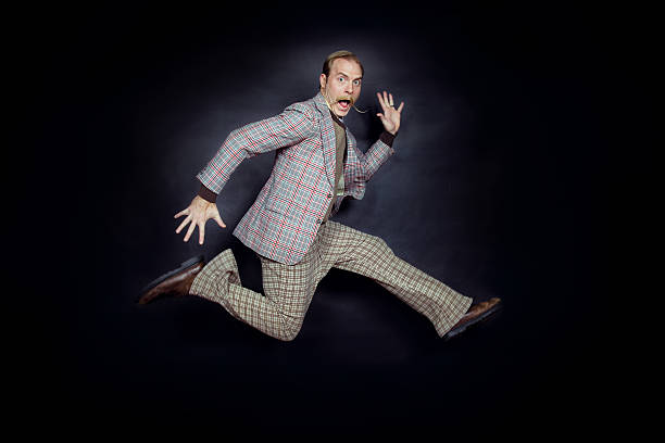 Jumping Man Man in vintage clothing taking a giant leap. Feet a little blurred due to fast jump. comb over stock pictures, royalty-free photos & images