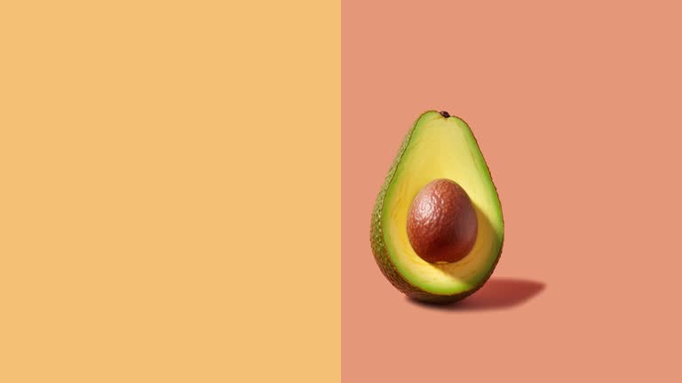 Stop motion Cut and whole Avocado appear and disappear on pastel background.