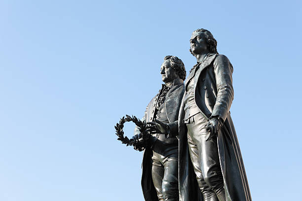 istock poet stautes Goethe and Schiller in Weimar against blue sky 155282374