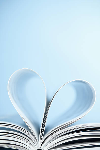 istock Love to read, pages folded into heart shape, blue background 155282873