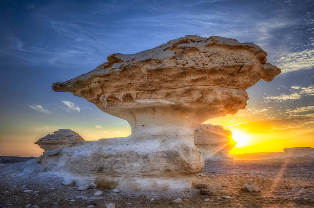 White Desert Sunset limestone rock formations in the white desert of Egypt to the sunset egypt horizon over land sun shadow stock pictures, royalty-free photos & images