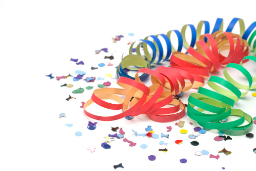 Party ribbon, confetti and horn blower isolated on white.