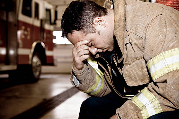 Tired firefighter stock photo