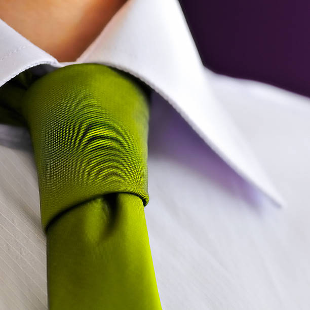 istock Management, close-up of green tie on lilac button down shirt 155283689