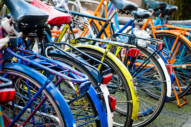 Bicycles in Amsterdam Group of bicycles parked next to Amsterdam Central railway station Amsterdam, Netherlands. bicycle rack photos stock pictures, royalty-free photos & images