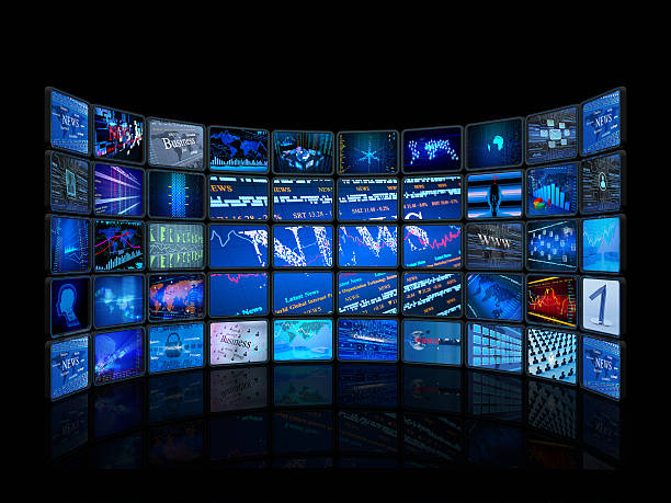 Digital monitors in a television studio A television studio, with 50 smaller screens lined up and arranged to form a big rectangle.  The floor is black and glossy, showing a reflection of the television screens. wall of monitors stock pictures, royalty-free photos & images