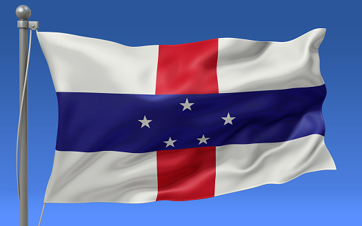 Netherlands Antilles flag waving on the flagpole on a sky background