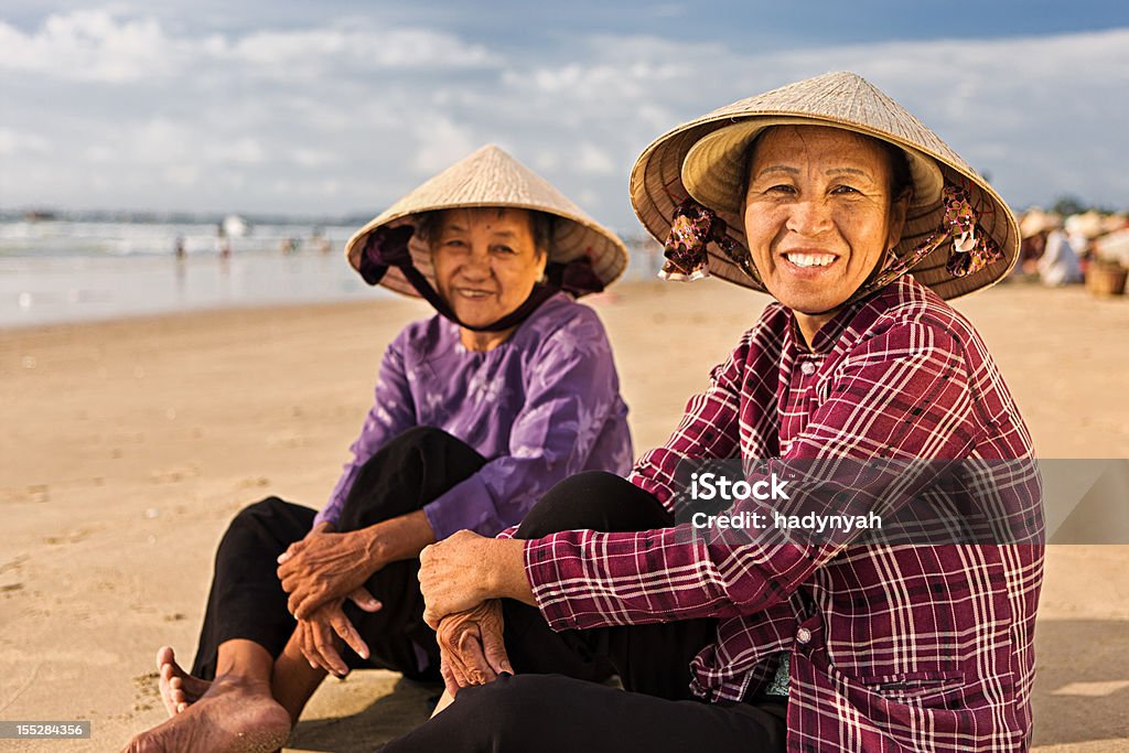 Two Vietnamese women sitting on the beach  Vietnam Stock Photo