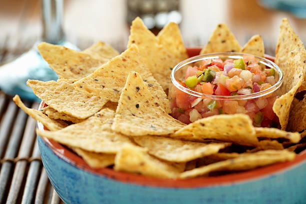 A close-up of a bowl of chips and salsa Chips and Salsa. tortilla chip photos stock pictures, royalty-free photos & images
