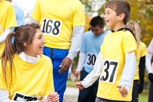 istock Teenage race participating laughing with young boy 155284453