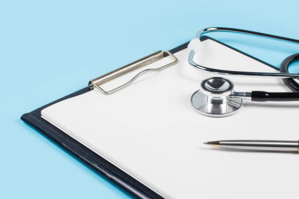 istock Stethoscope and pen laying on patient information blank 1552845108