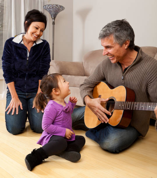 istock grandparents playing guitar for granddaughter 155284762