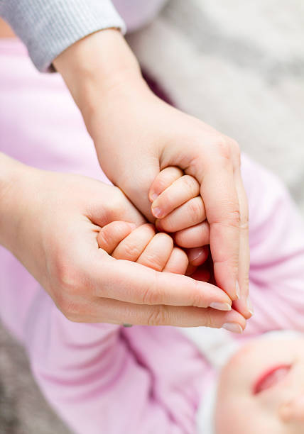 Mother holding daughter's hands  unicef stock pictures, royalty-free photos & images
