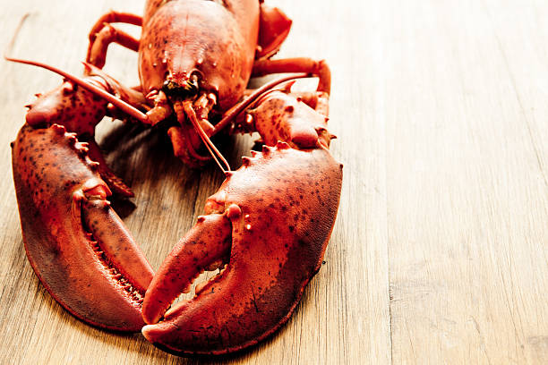 Close-up of lobster on wooden table stock photo
