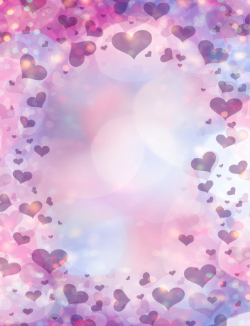 Background made of defocused lights and hearts of various sizes. Ideal for Valentine's Day.