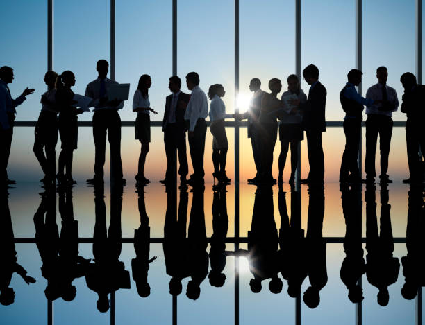 istock Sunset silhouette of business colleagues working 155285295
