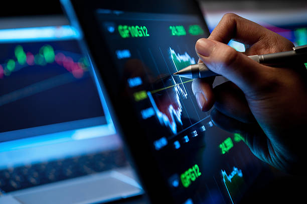 Market Analyze Market Analyze with Digital Moniter focus on tip of finger. stock market and exchange stock pictures, royalty-free photos & images