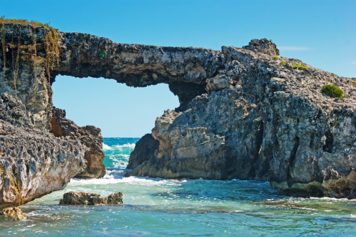 Hells' gate natural rock arch which is off Bird Island to the North east of Antigua.  The gate is shaped like Africa or an Elephants Head.