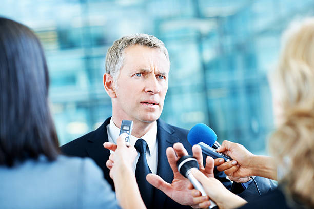No comment Annoyed businessman standing with the press swamping him with questions as he pushes a microphone away senator photos stock pictures, royalty-free photos & images
