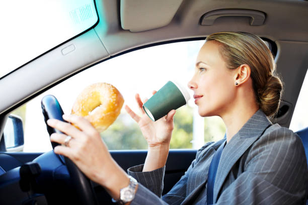 Businesswoman Driving to Work and Having Breakfast.