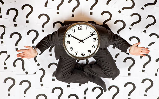 Business man with a clock head surrounded by question marks Businessman with a clock calendar 2012 stock pictures, royalty-free photos & images