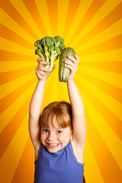 istock Happy Young Girl Holding Broccoli Above Her Head 155285546