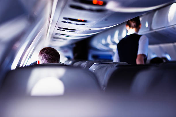 Flying with airplane Airplane cabin during flight. Shallow DOF, selective focus.  airplane interior stock pictures, royalty-free photos & images