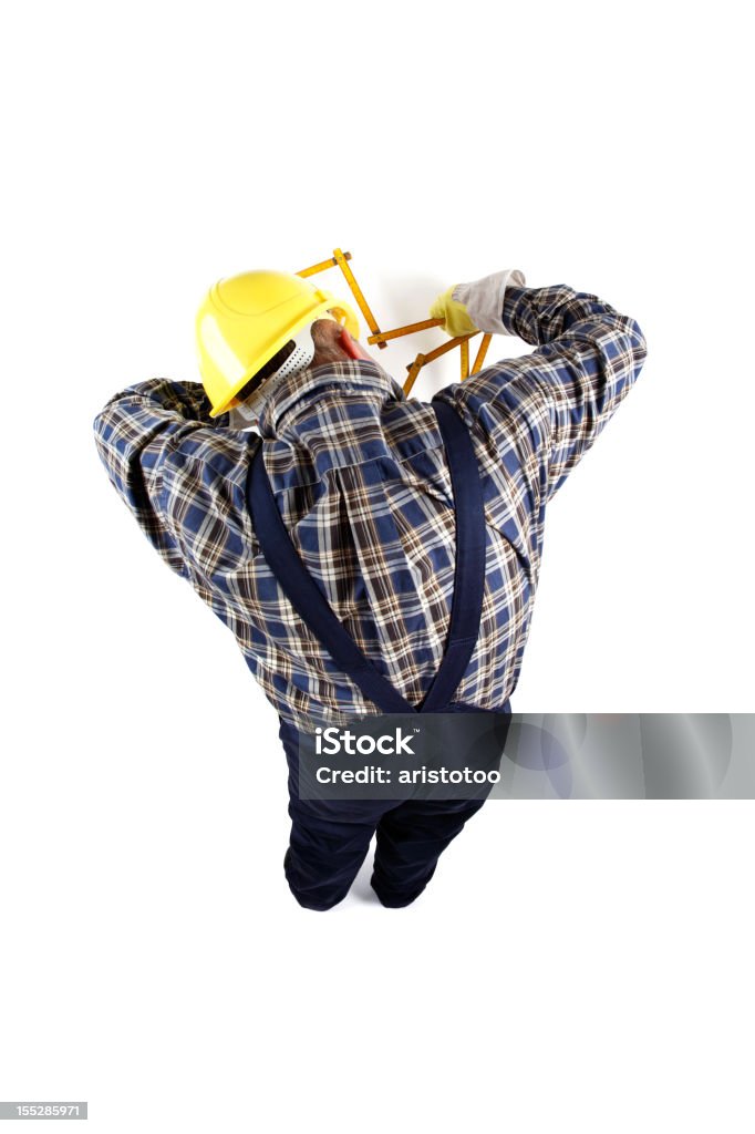 Clumsy Manual Worker Measuring with Folding Ruler Clumsy Manual Worker Measuring with Folding Ruler. 40-44 Years Stock Photo