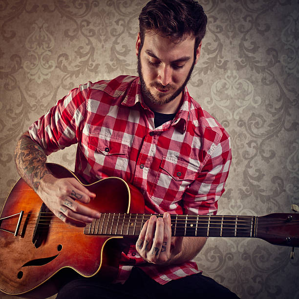 istock Young Man Playing a Vintage Guitar 155286034