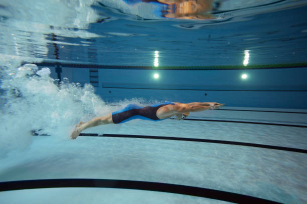 istock Swimmer diving after the jump in swimming pool 155286498
