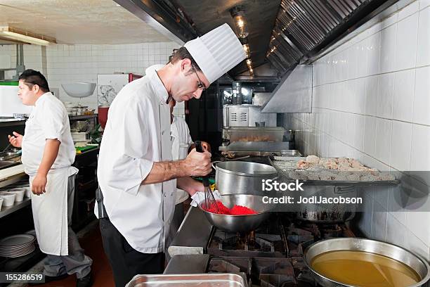 Chefs Cooking In A Commercial Kitchen Stock Photo - Download Image Now - Adult, Apron, Baked Pastry Item
